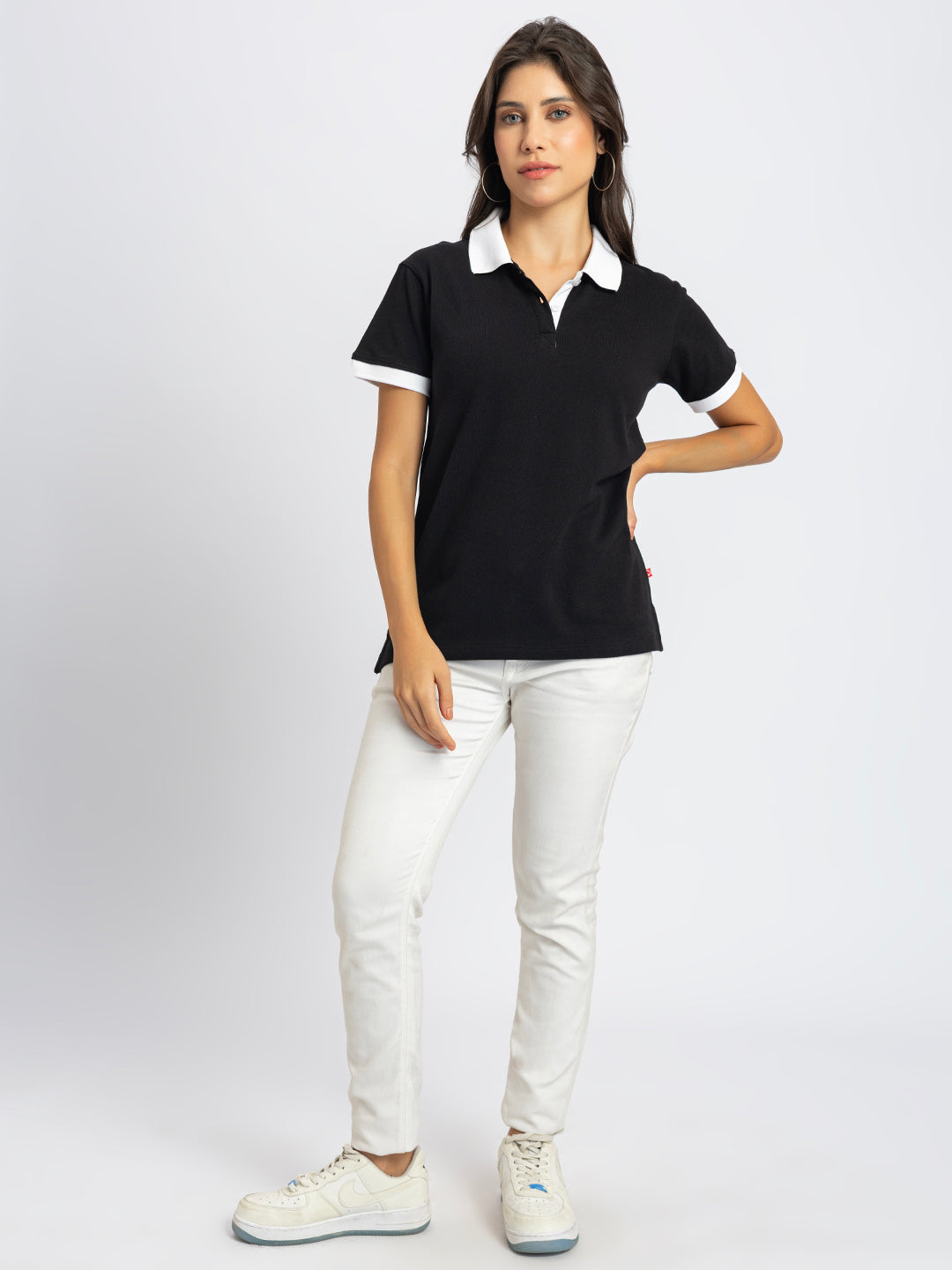 Close-up of white contrast collar on black polo