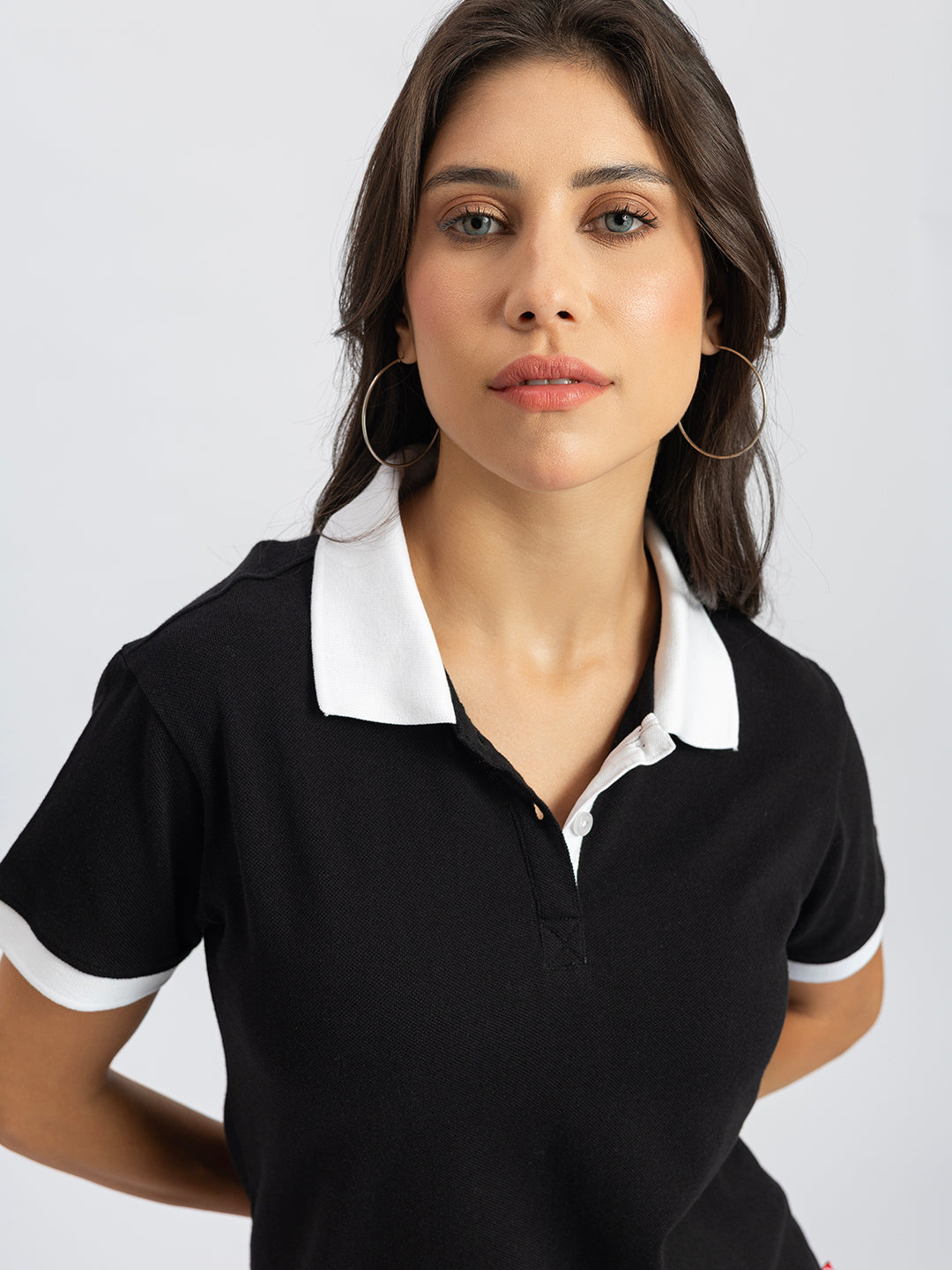 Styling shot of black polo with denim