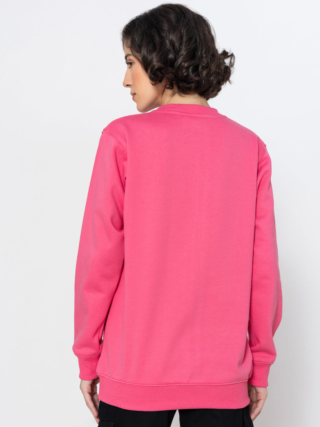 Lifestyle shot of pink sweatshirt styled with joggers
