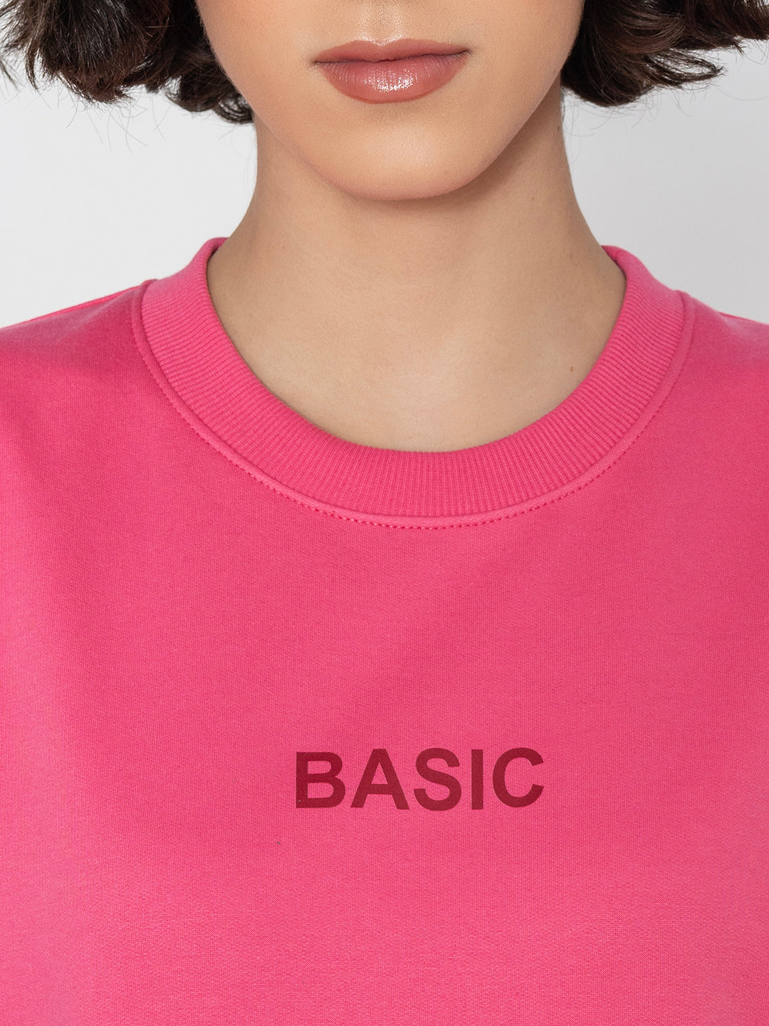 Detail of crew neck on pink cotton blend sweatshirt
