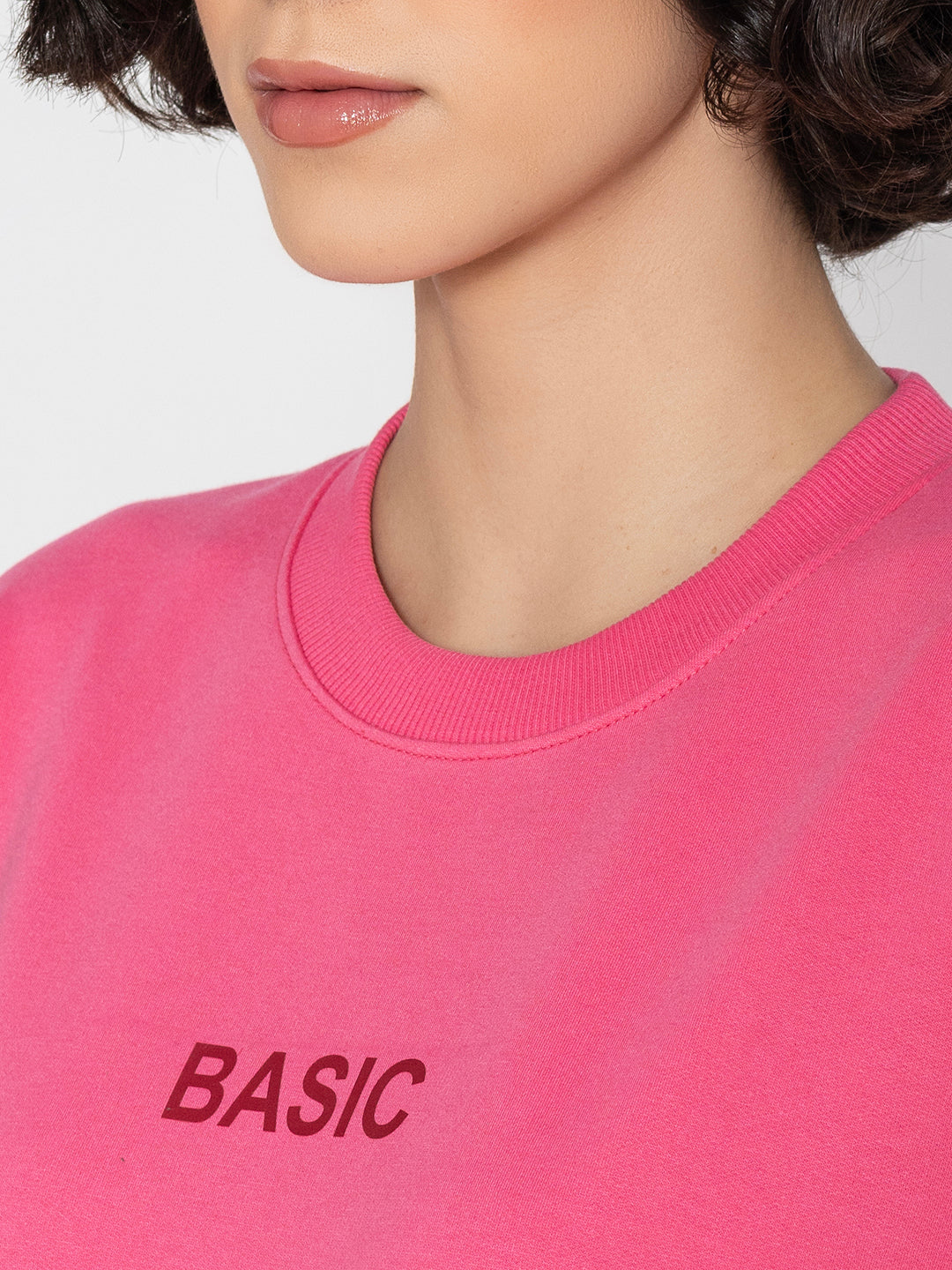 Model wearing pink sweatshirt in a casual everyday look