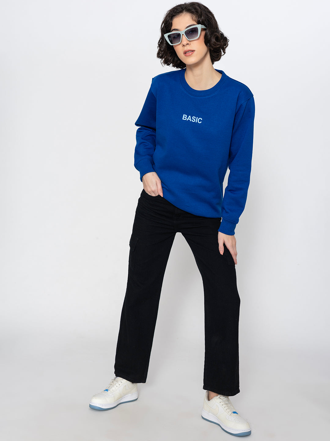 Model wearing blue sweatshirt in a casual everyday look