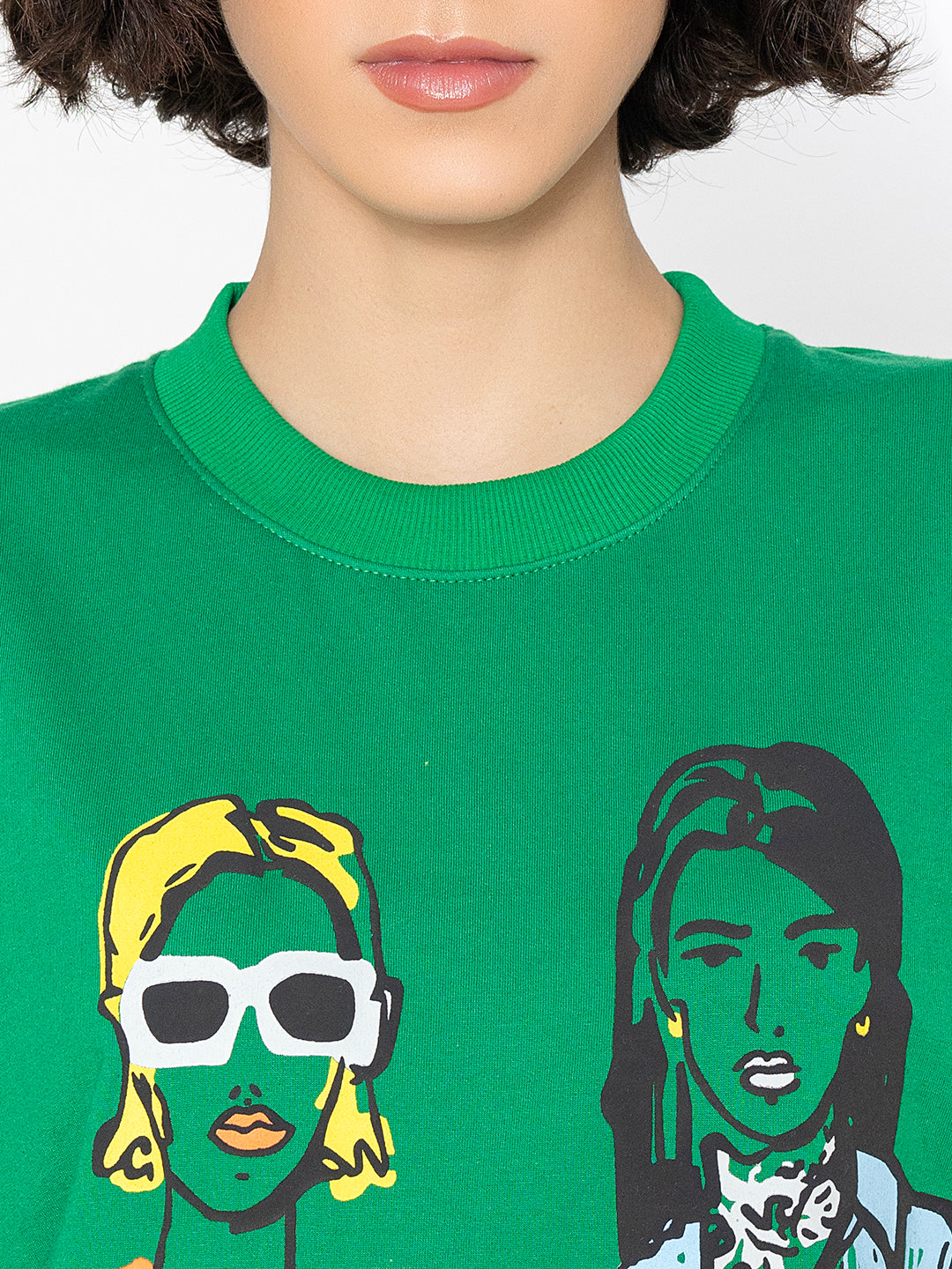 Lifestyle shot of green print sweatshirt with jeans