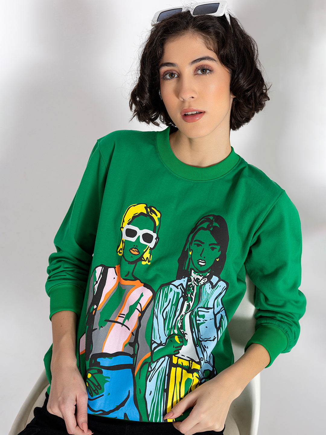 Close-up of illustrated graphic on green sweatshirt