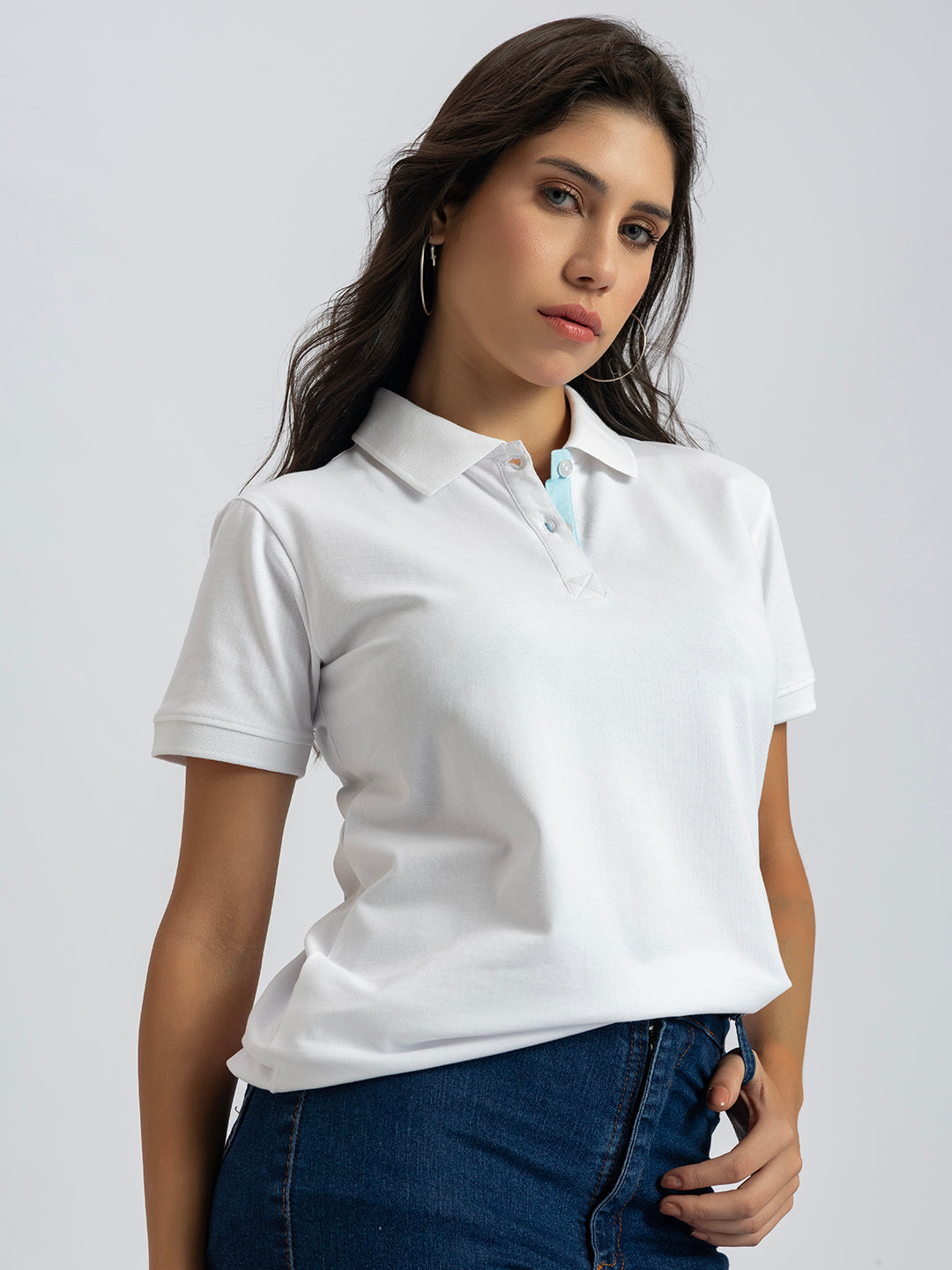 Lifestyle shot of woman wearing white polo