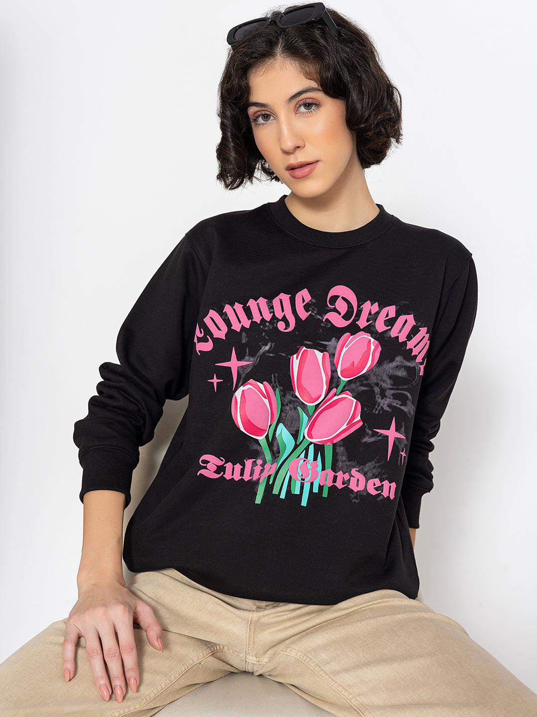 Close-up of tulip garden print on black sweatshirt