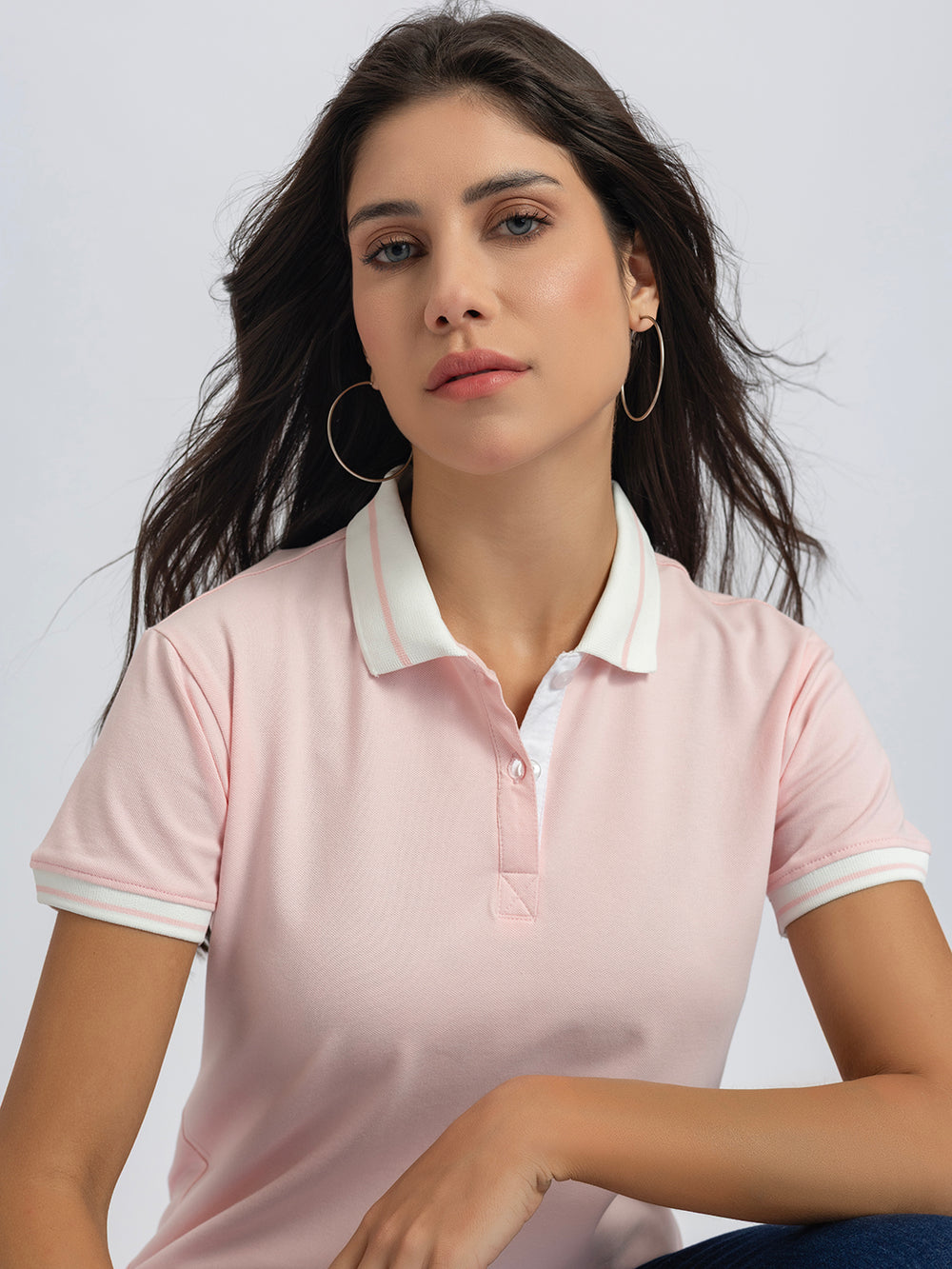Side view of light pink polo T-shirt with striped collar