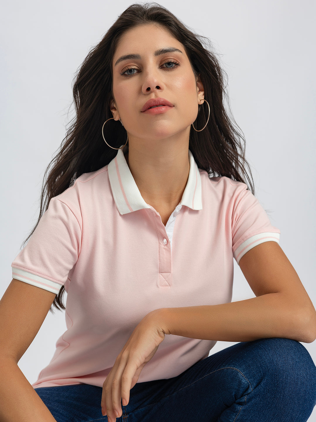 Detail of long sleeve cuff on light pink cotton polo