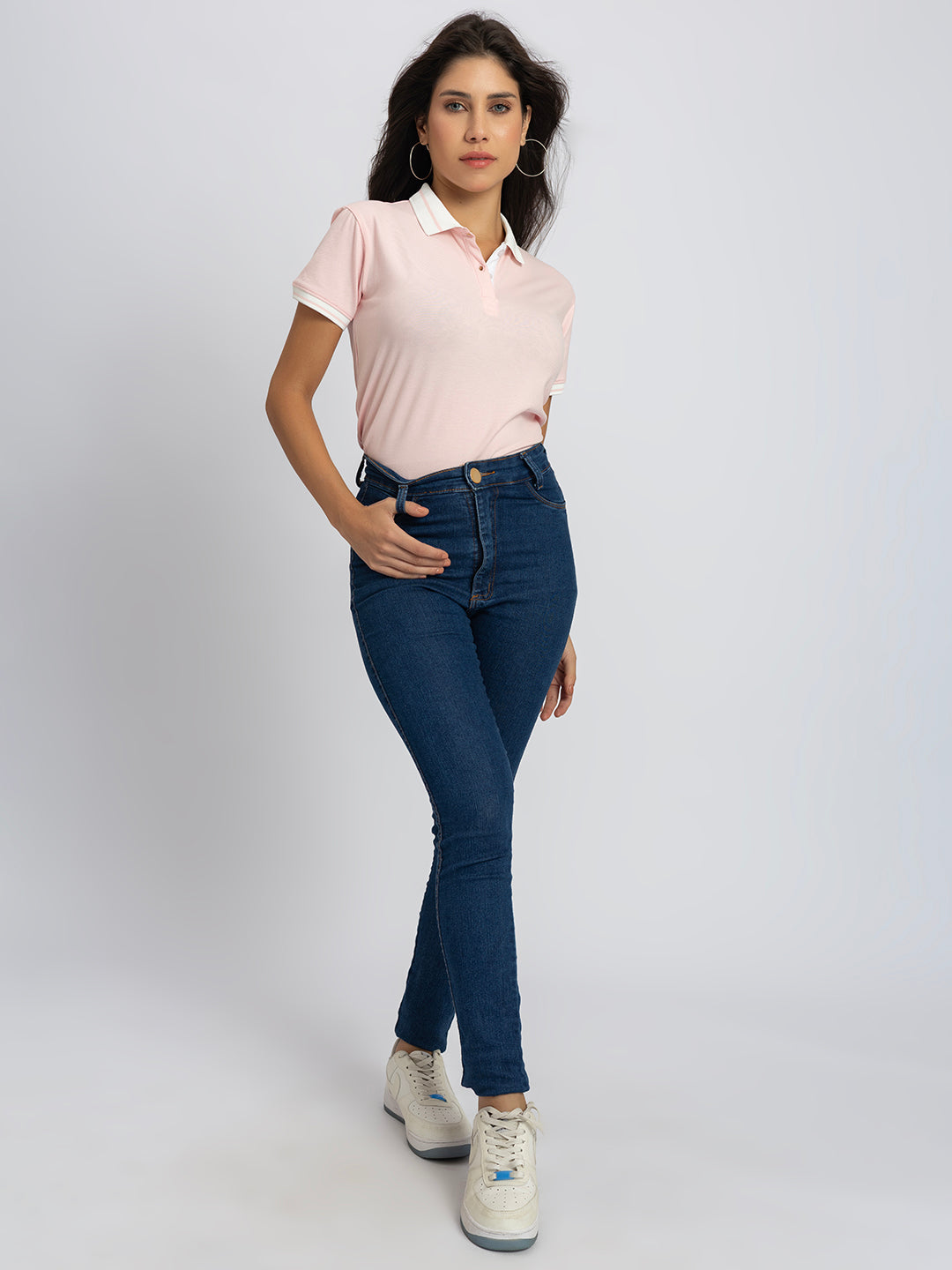 Close-up of striped contrast collar on light pink polo