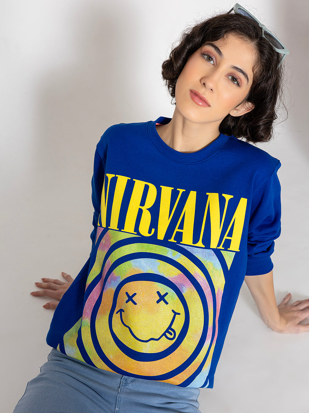 Lifestyle shot of blue graphic sweatshirt with jeans