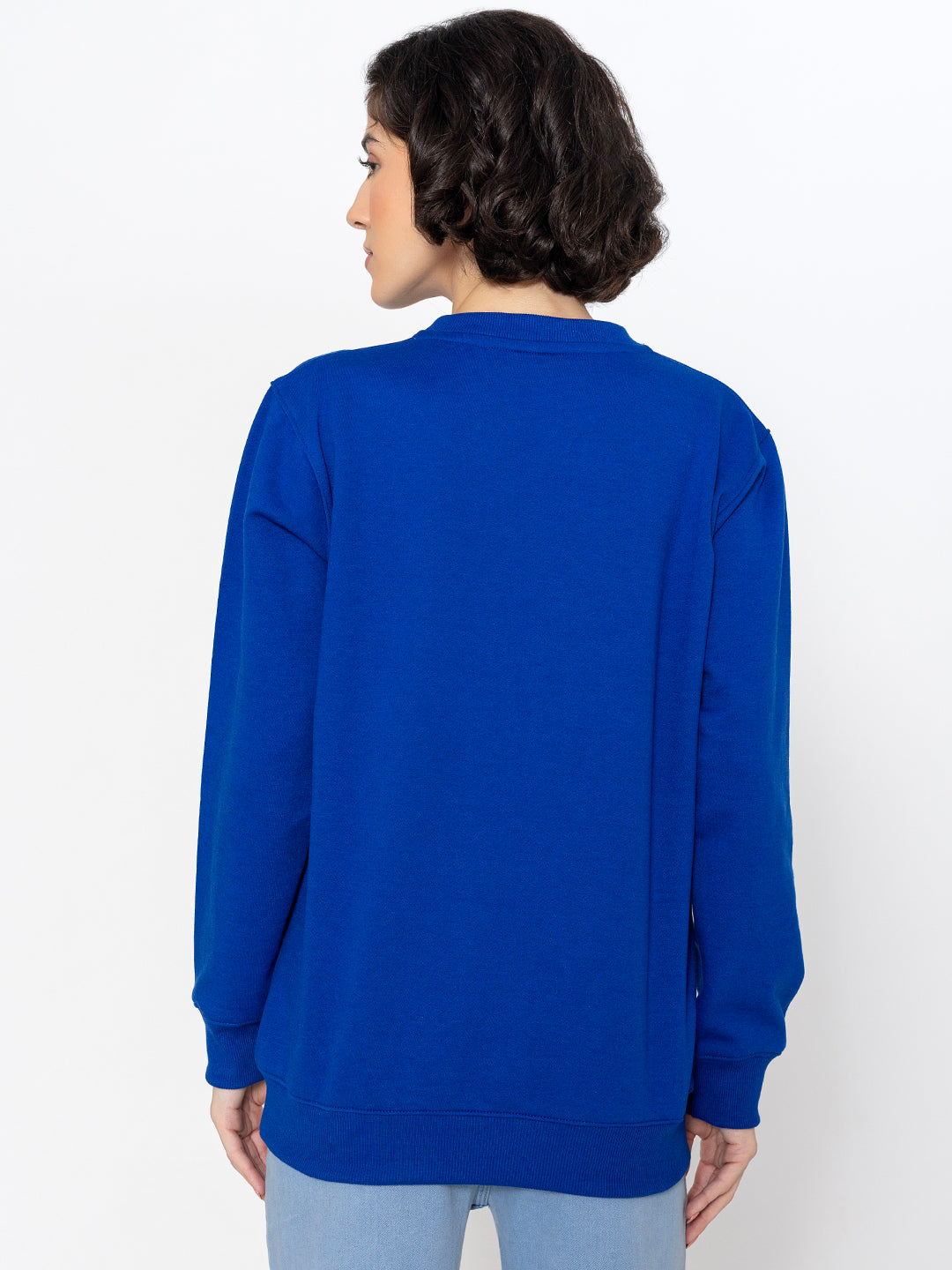 Blue illustrated sweatshirt shown in soft daylight