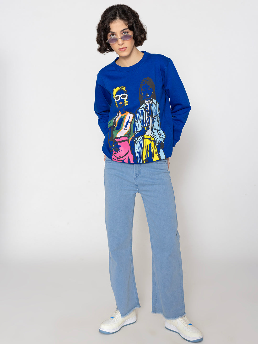 Lifestyle shot of blue print sweatshirt with jeans