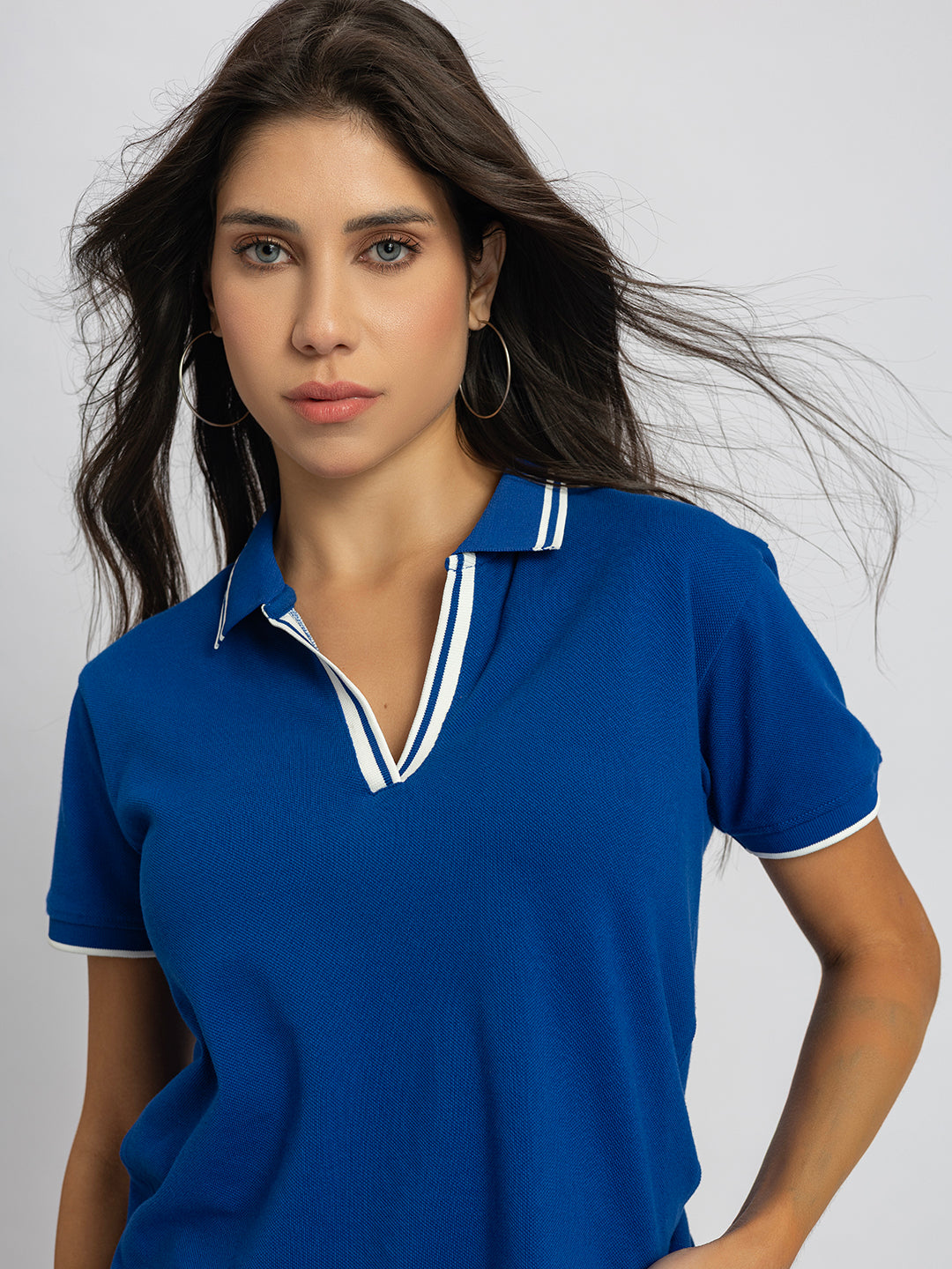 Detail of long sleeve cuff on royal blue cotton polo