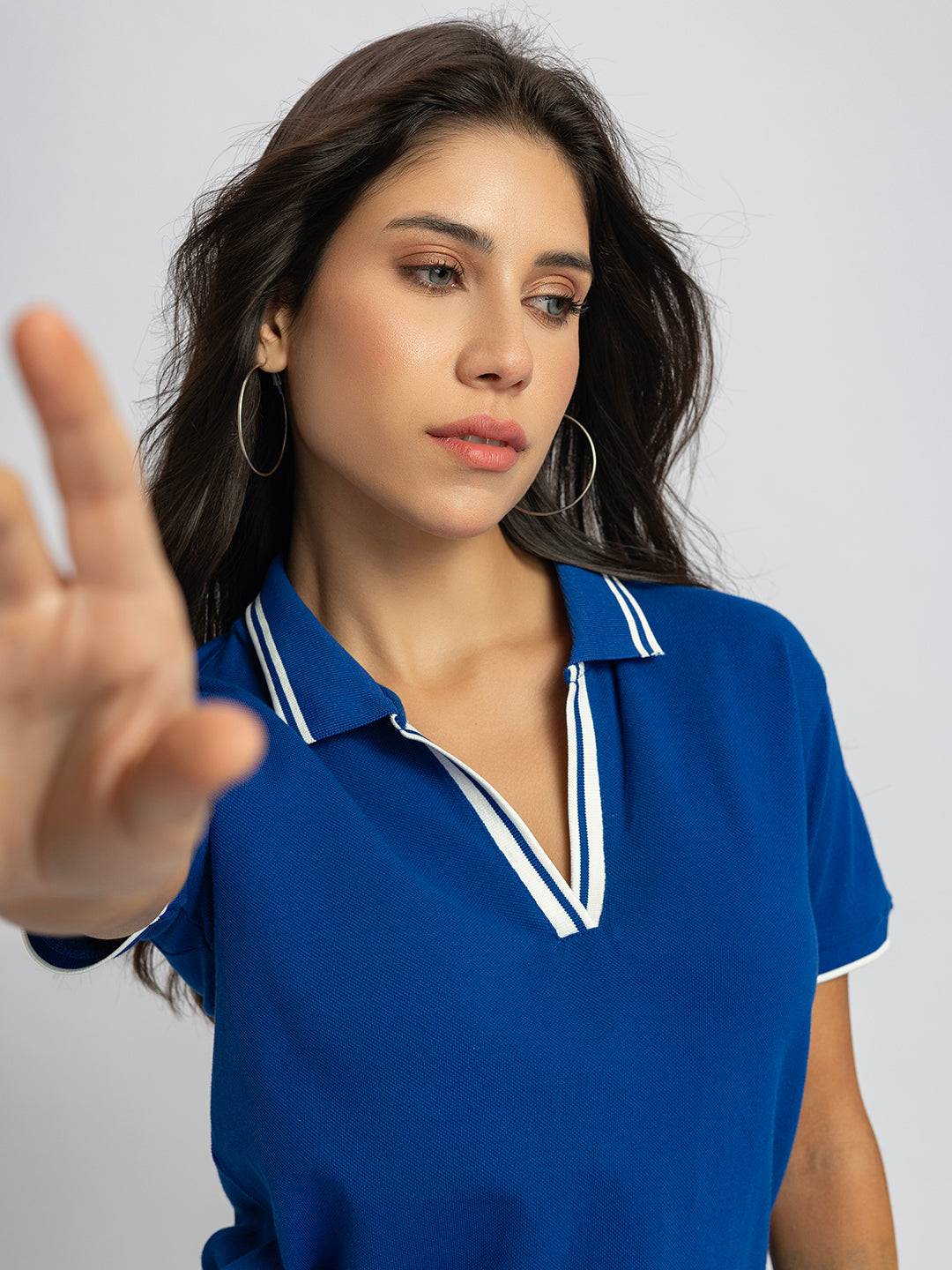 Side view of royal blue polo T-shirt with striped collar