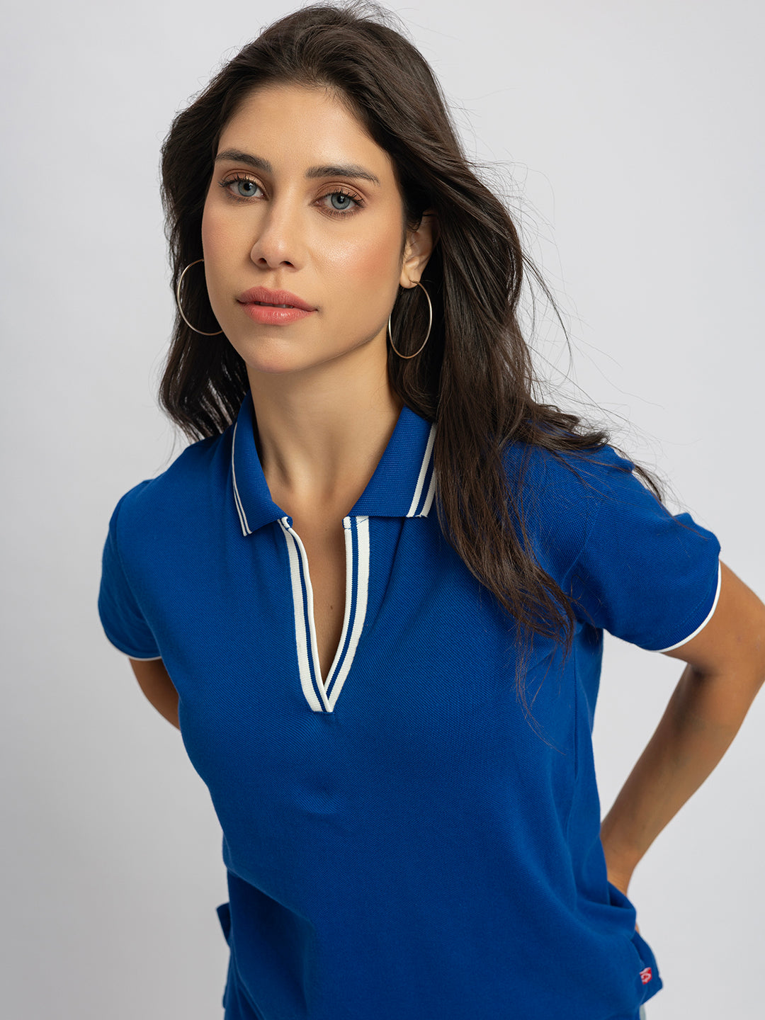 Styling shot of royal blue polo T-shirt with chinos
