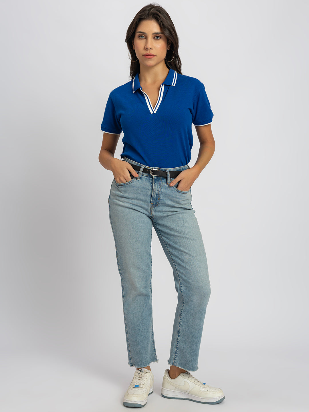 Close-up of striped contrast collar on royal blue polo
