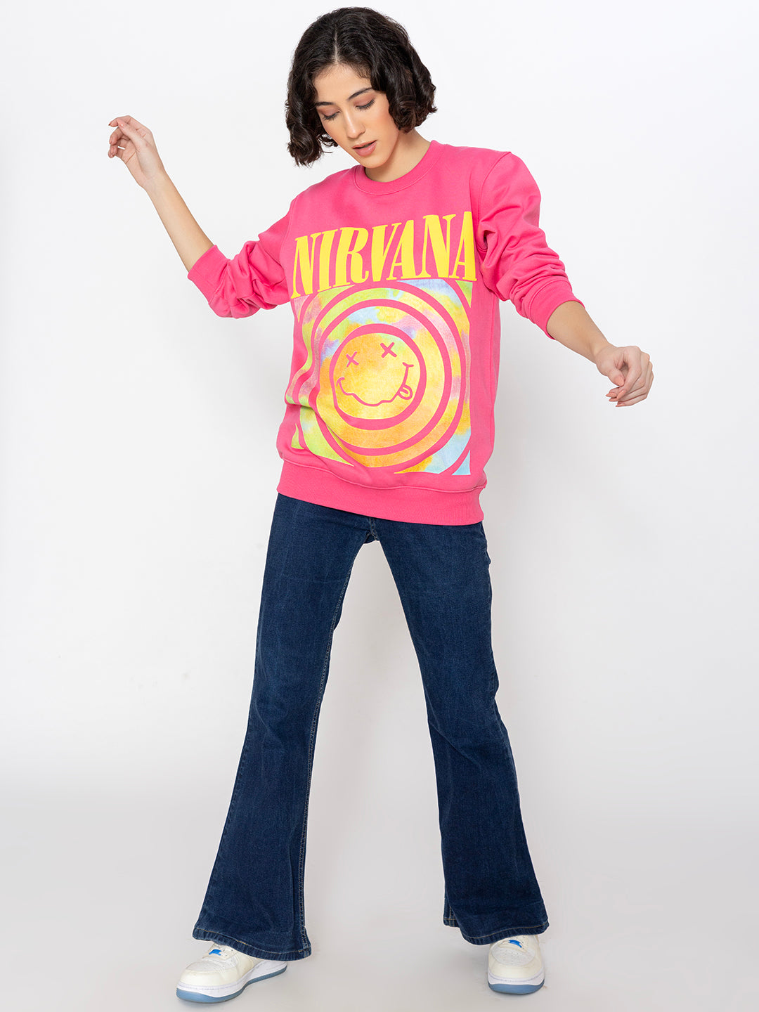 Lifestyle shot of pink graphic sweatshirt with jeans