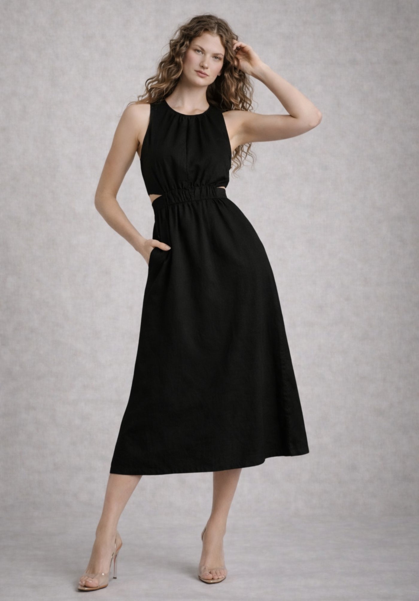 Side view of black A-line dress showing flared skirt