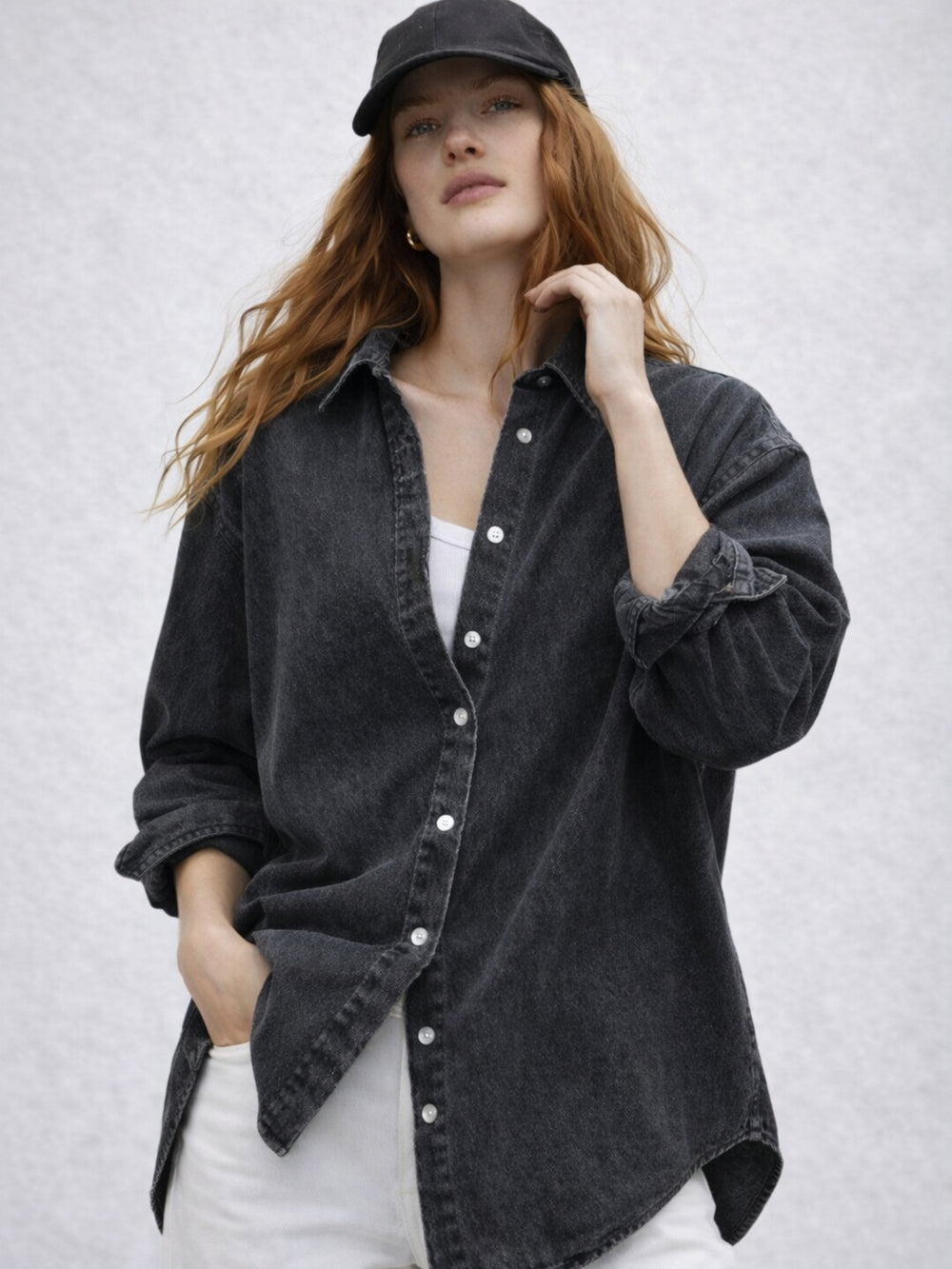 Side view of black oversized denim shirt with spread collar