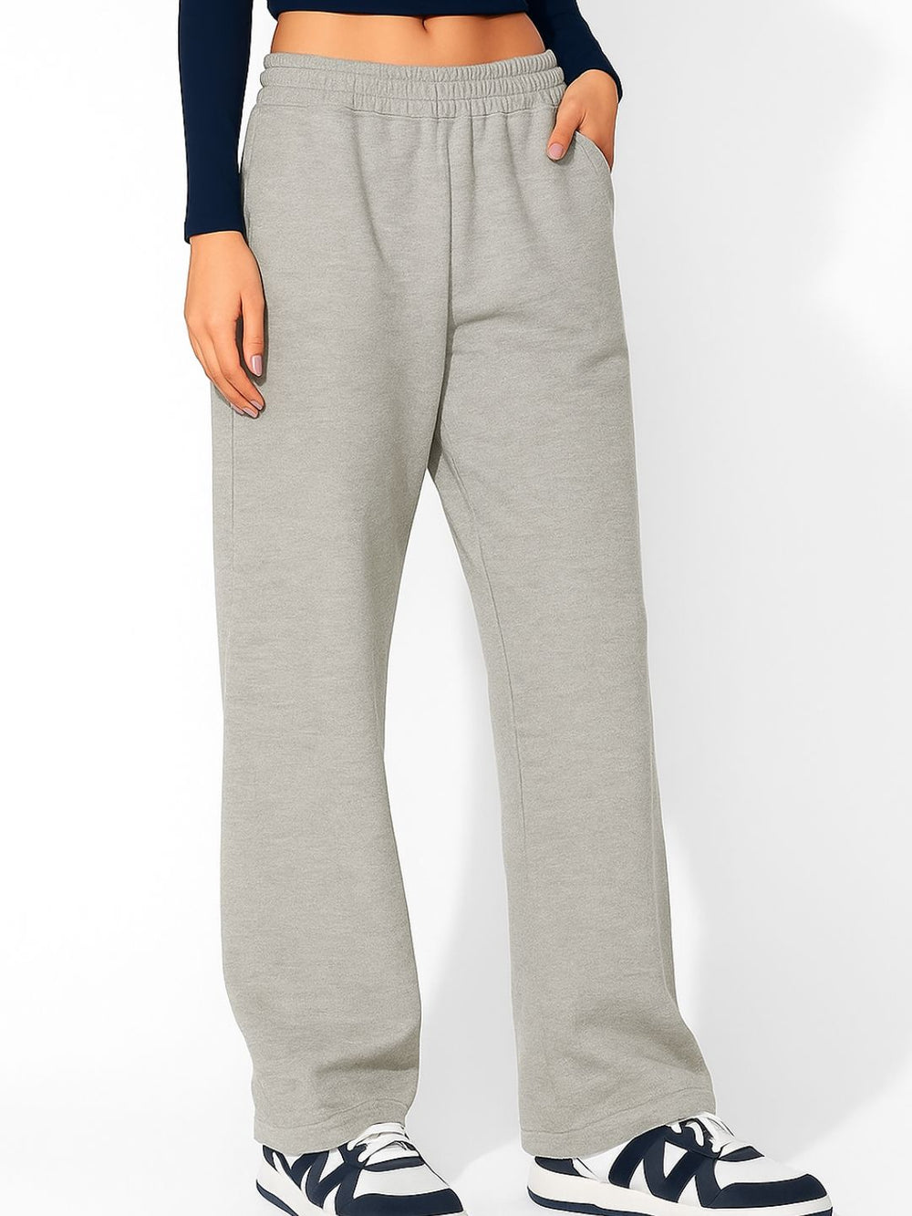 Grey track pants styled with white tee and sneakers