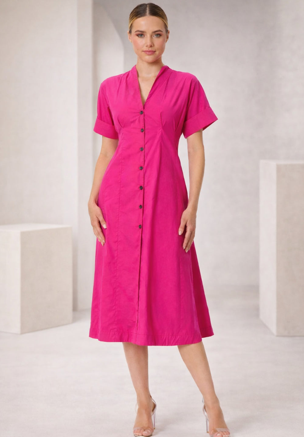 Side view of pink cotton A-line dress showing flared skirt