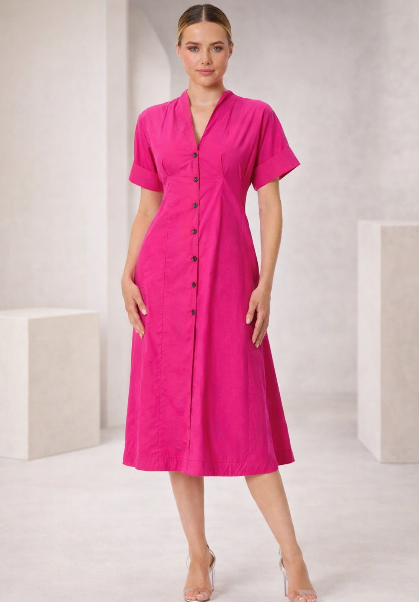 Side view of pink cotton A-line dress showing flared skirt
