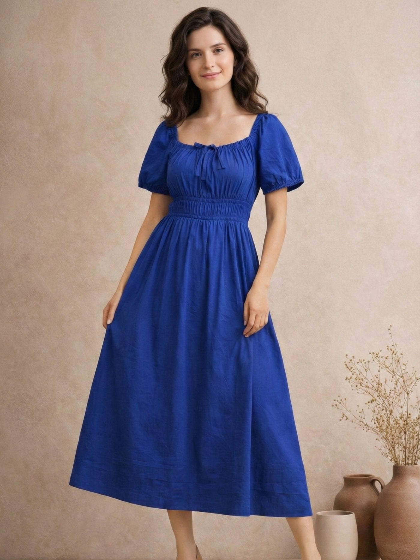 Side view of blue cotton midi dress with smocked waist detail