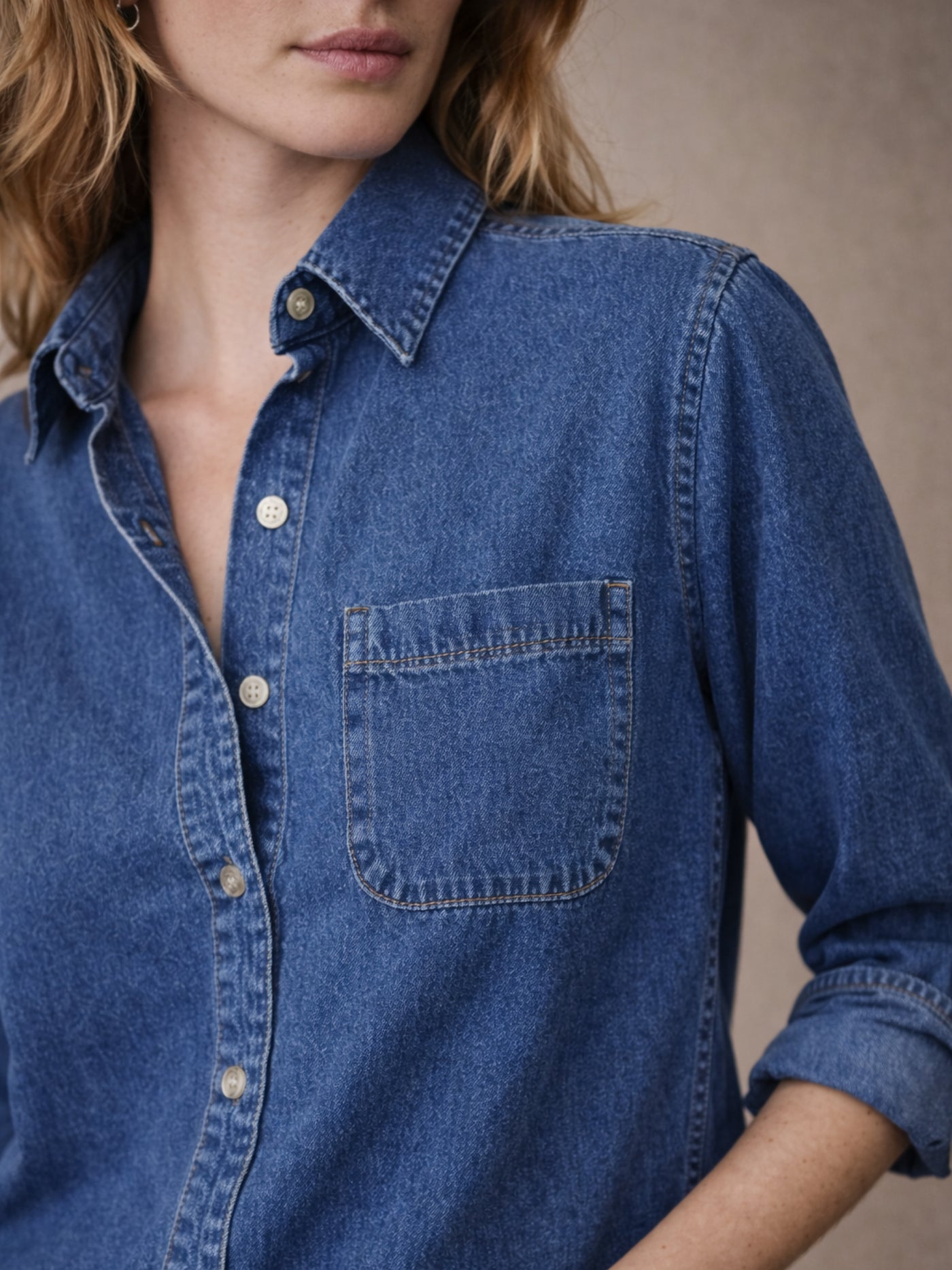 Lifestyle shot of dark blue denim shirt styled with denim