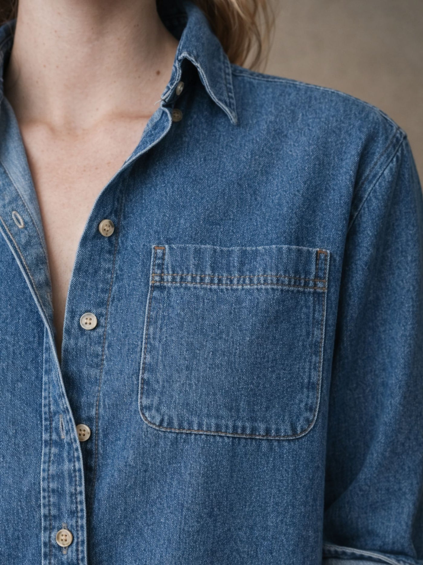 Lifestyle shot of blue denim shirt styled open over a tee