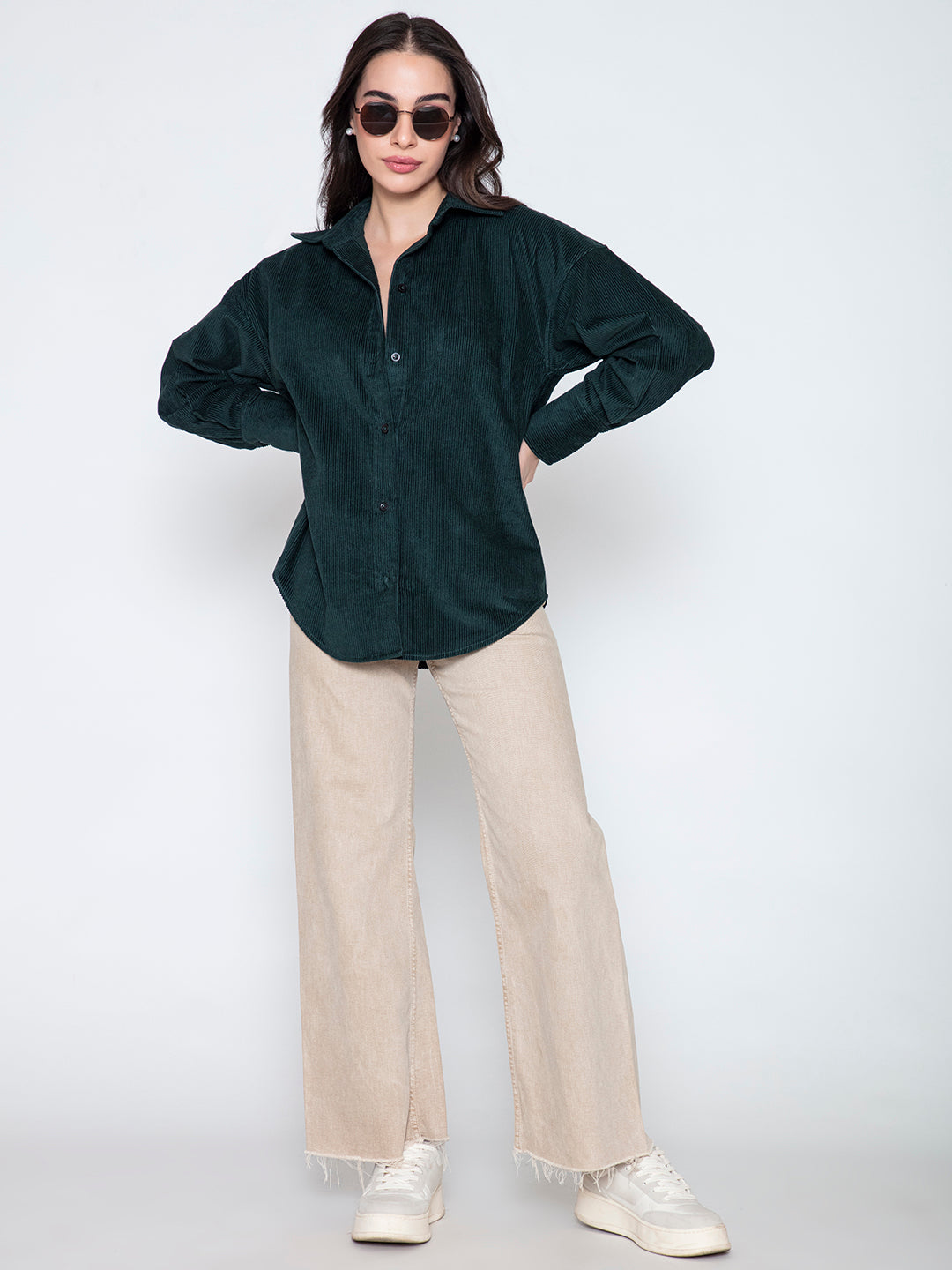 Detail of curved hem and button placket on green corduroy shirt