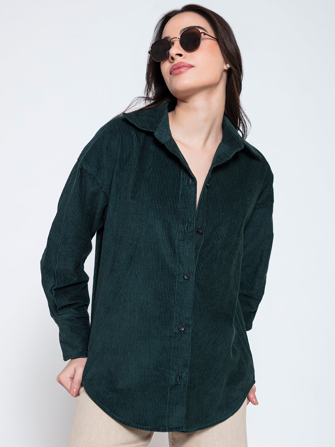 Lifestyle shot of model wearing green corduroy oversized shirt