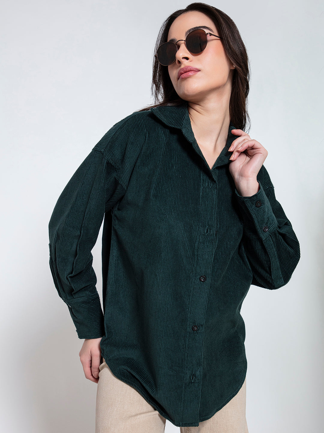 Front view of green oversized corduroy shirt for women