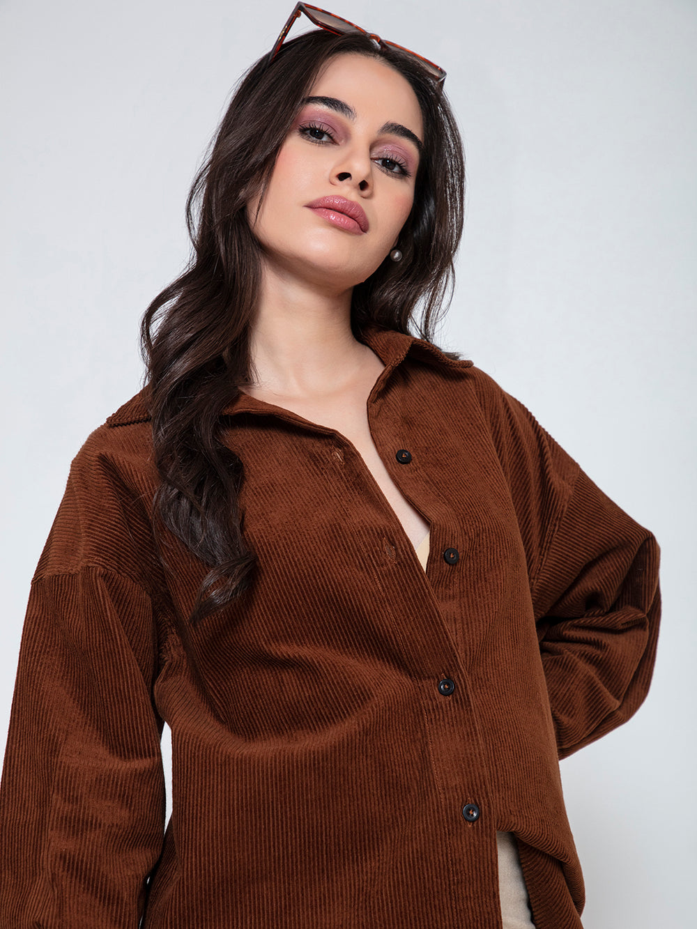 Side angle of brown corduroy oversized shirt with spread collar