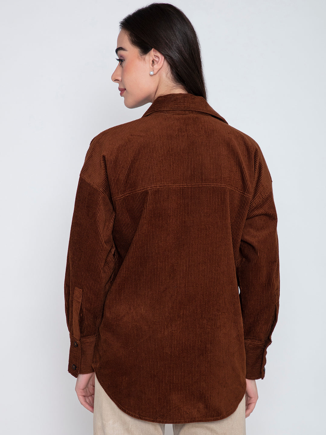 Lifestyle shot of model wearing brown corduroy oversized shirt