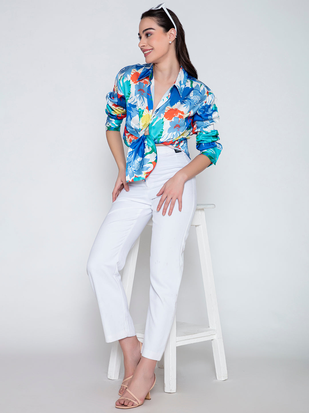 Lifestyle shot of model wearing blue floral satin shirt