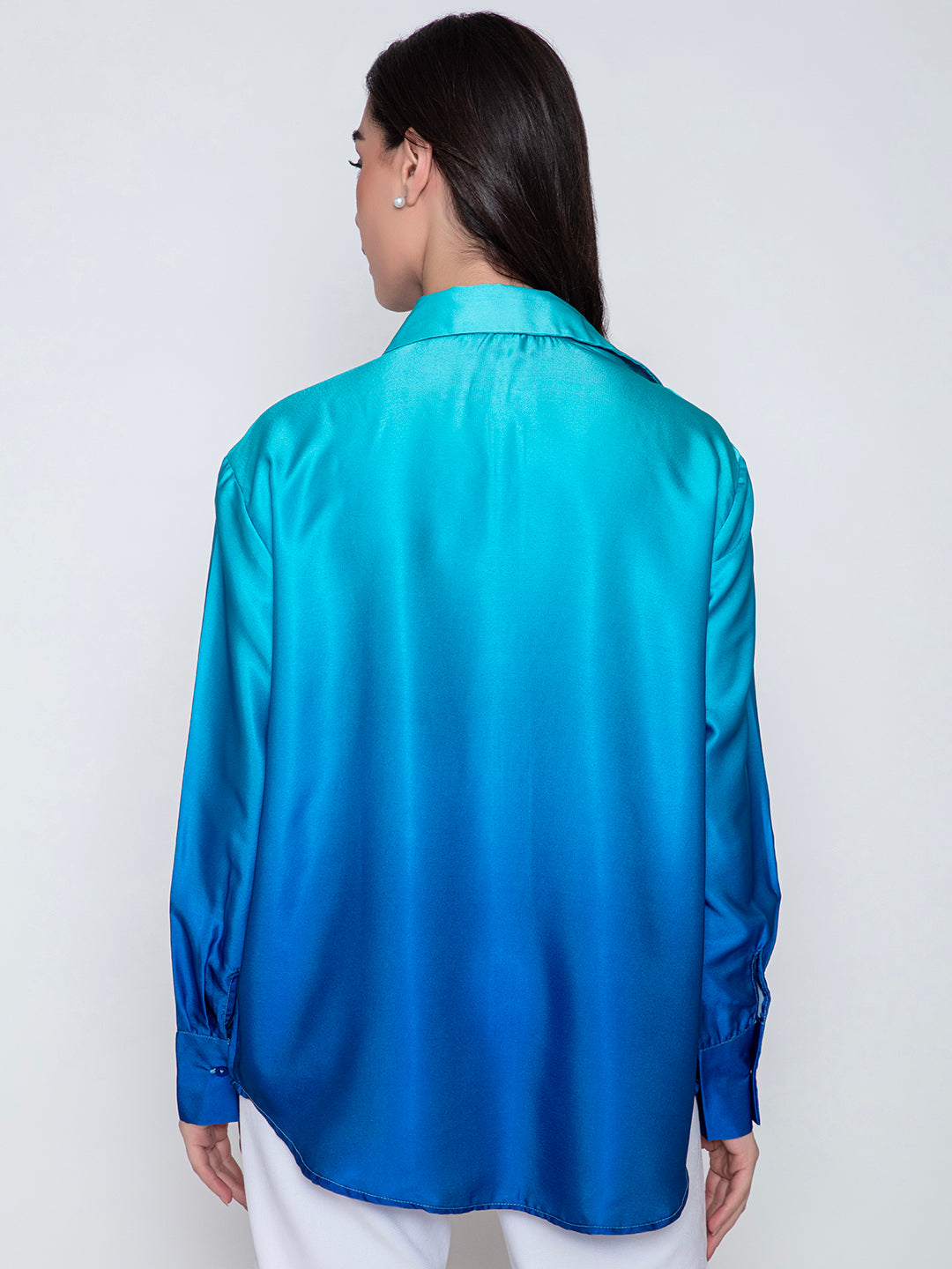 Detail of cuff and button placket on blue satin shirt