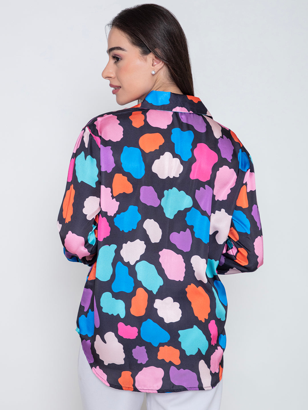 Lifestyle shot of woman wearing multi print satin shirt
