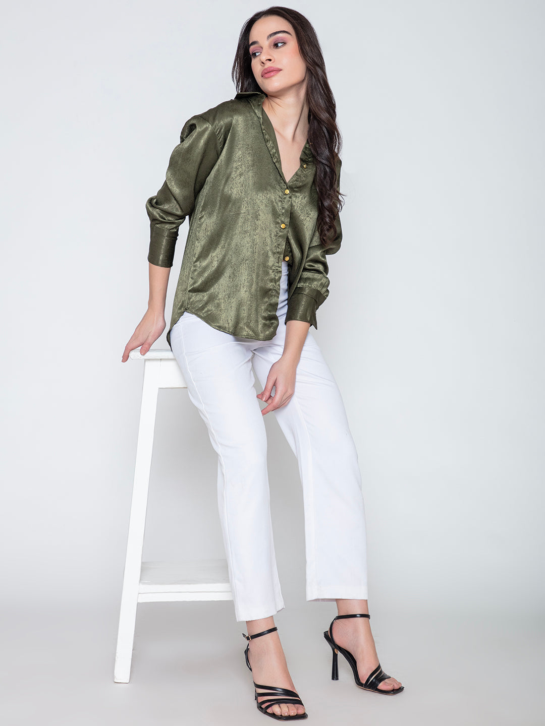 Detail of cuff and button placket on green satin shirt