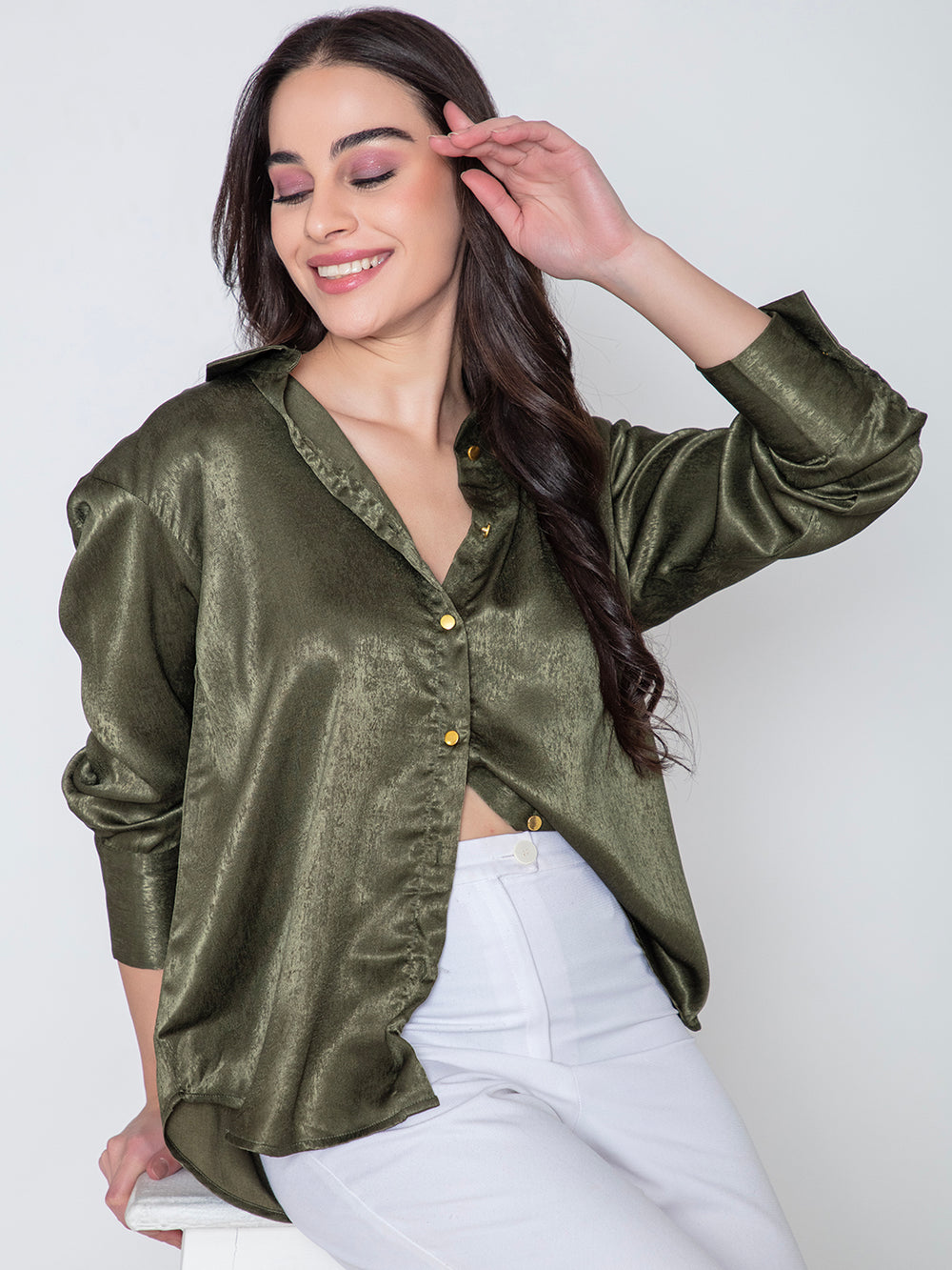 Side angle of green satin shirt with soft drape