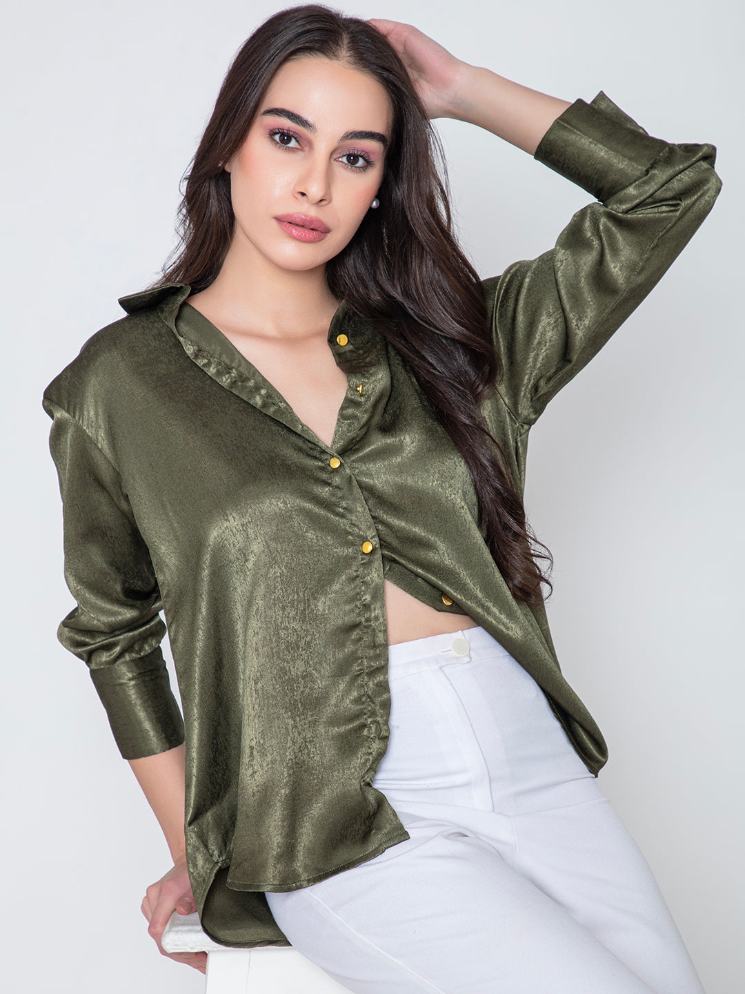 Lifestyle shot of model wearing green satin relaxed shirt