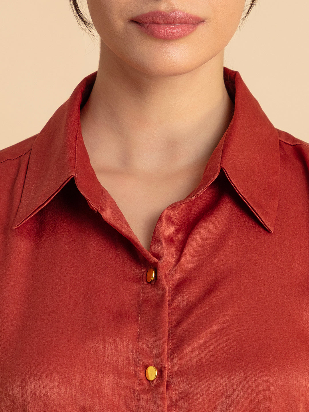 Detail of shirt collar on maroon satin set