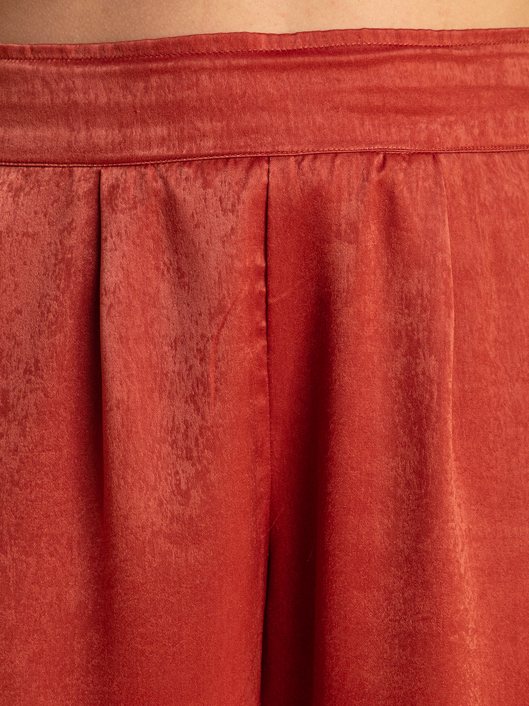 Lifestyle shot of model wearing maroon satin co-ord set
