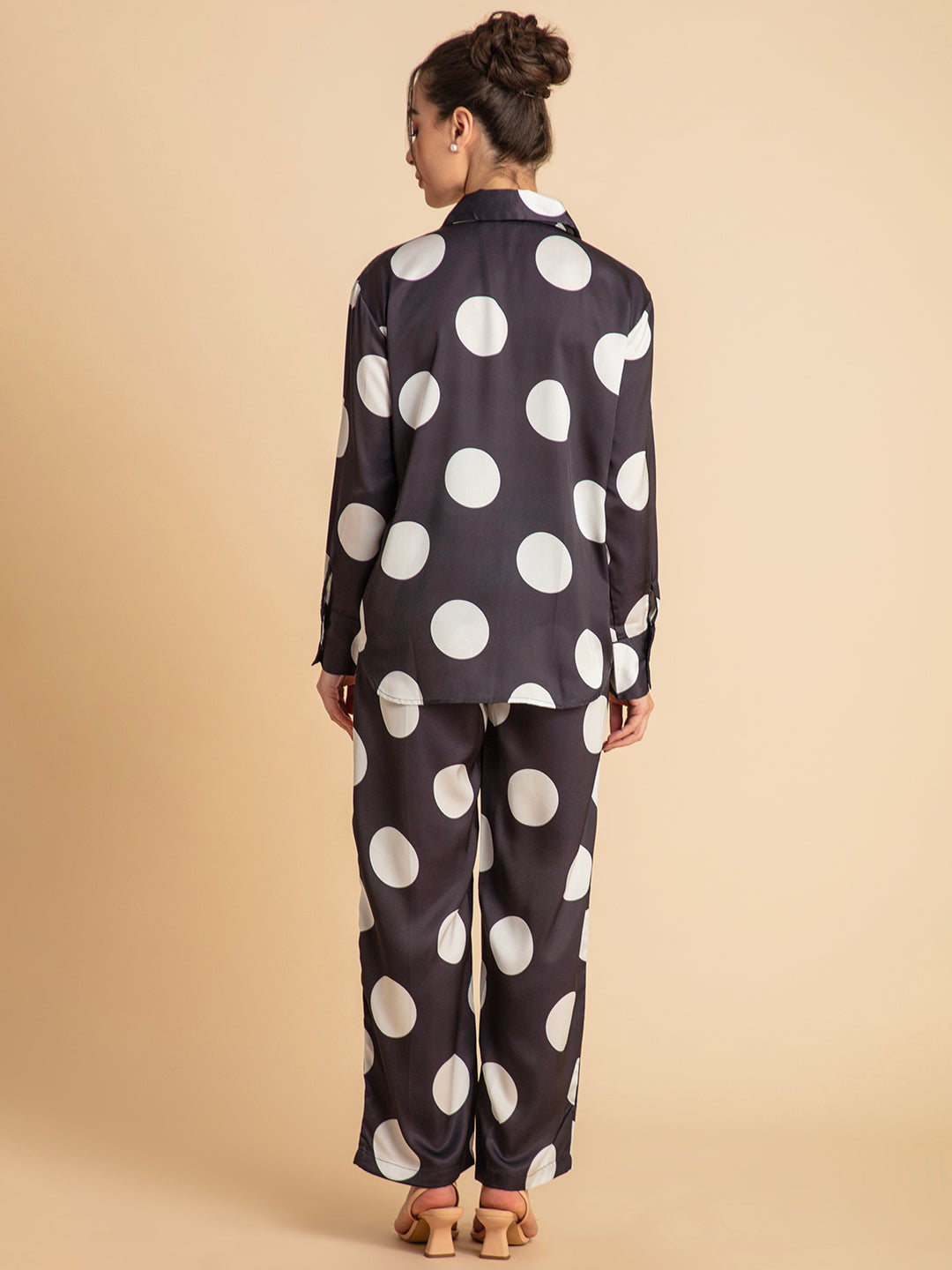 Curved hemline of polka dot satin shirt