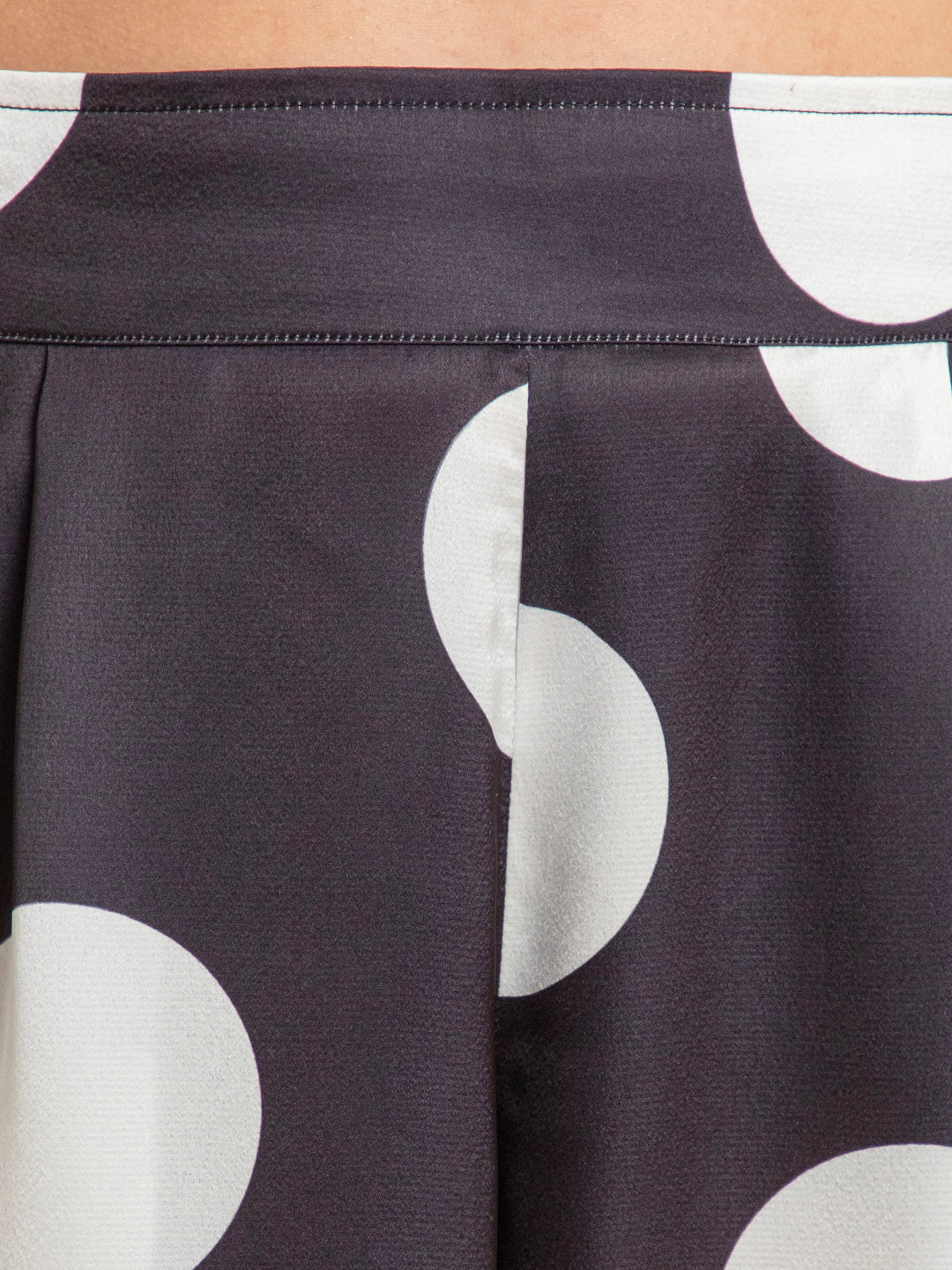 Lifestyle shot of woman wearing polka dot satin co-ord
