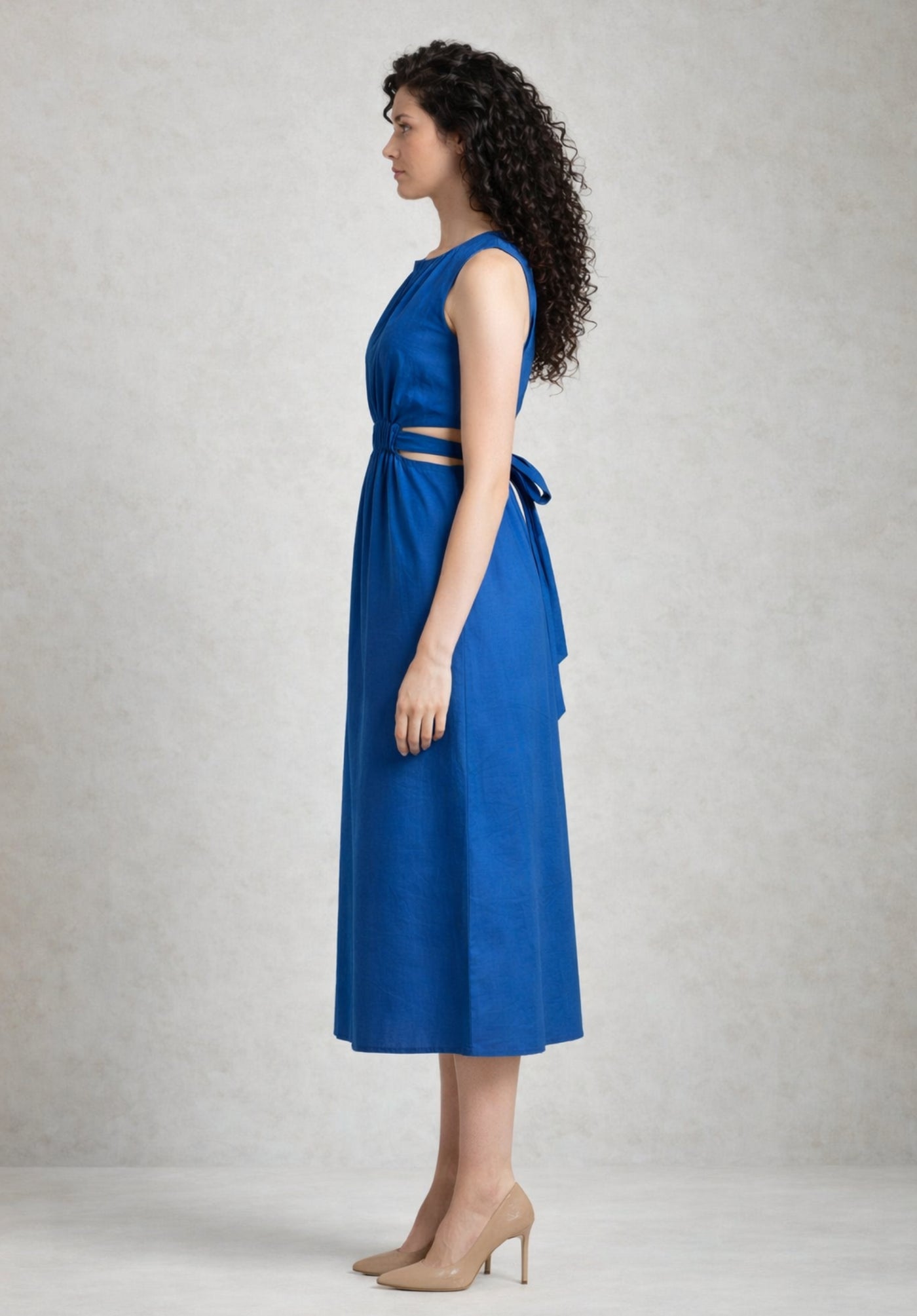 Side angle of blue cotton A-line dress showing flared skirt