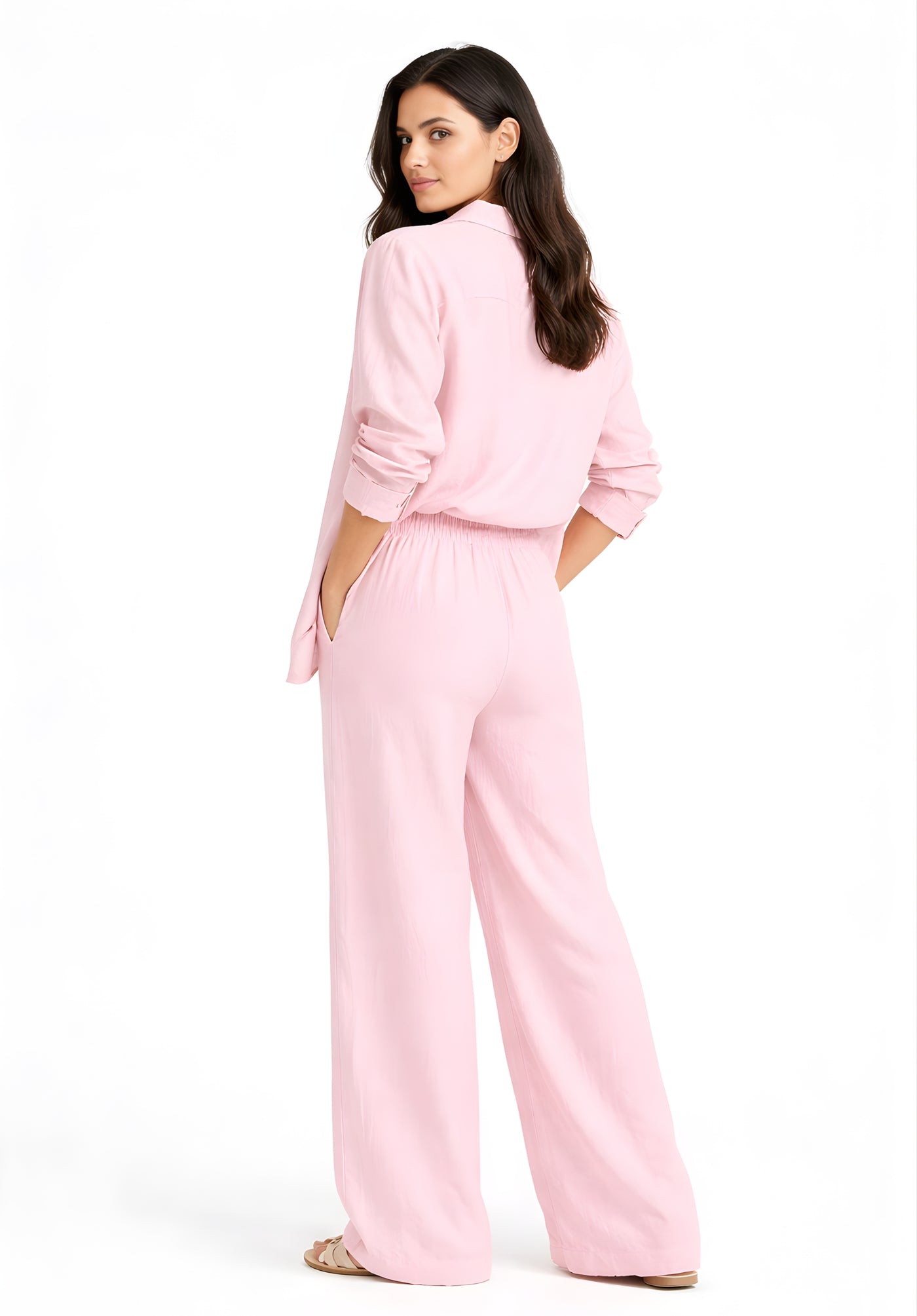 Back view of light pink linen blend trousers showing baggy straight leg silhouette