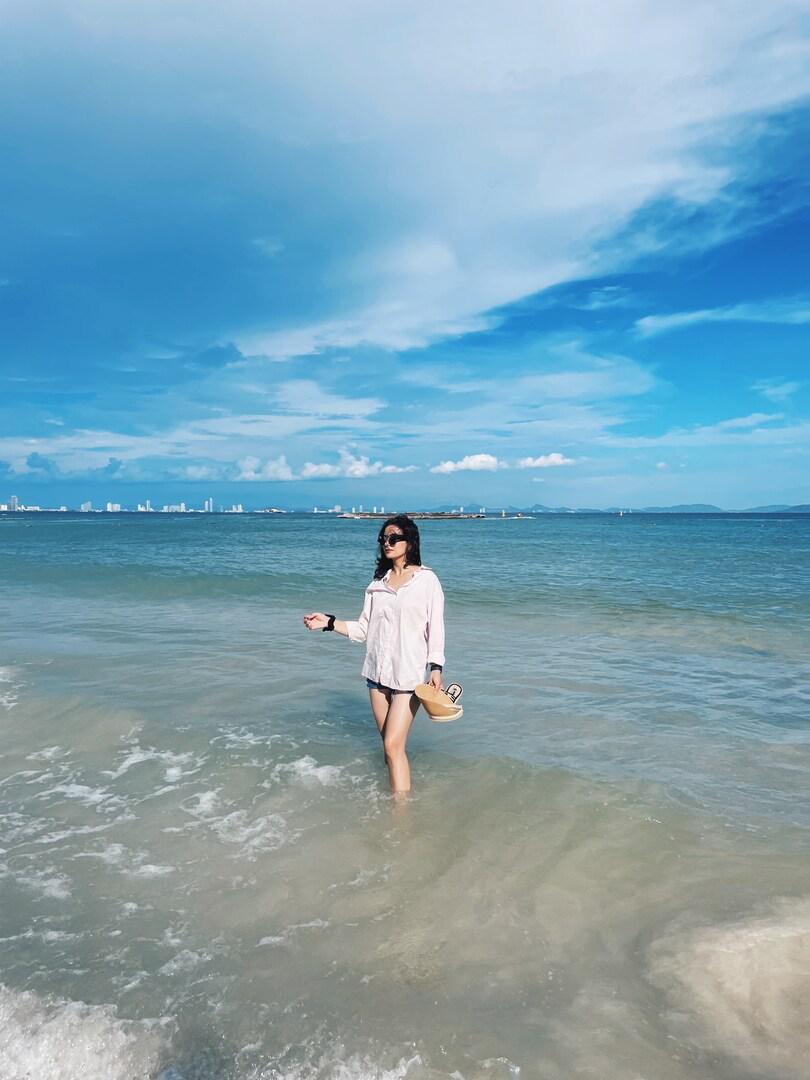 Lifestyle shot of woman wearing light pink cotton poplin oversized shirt