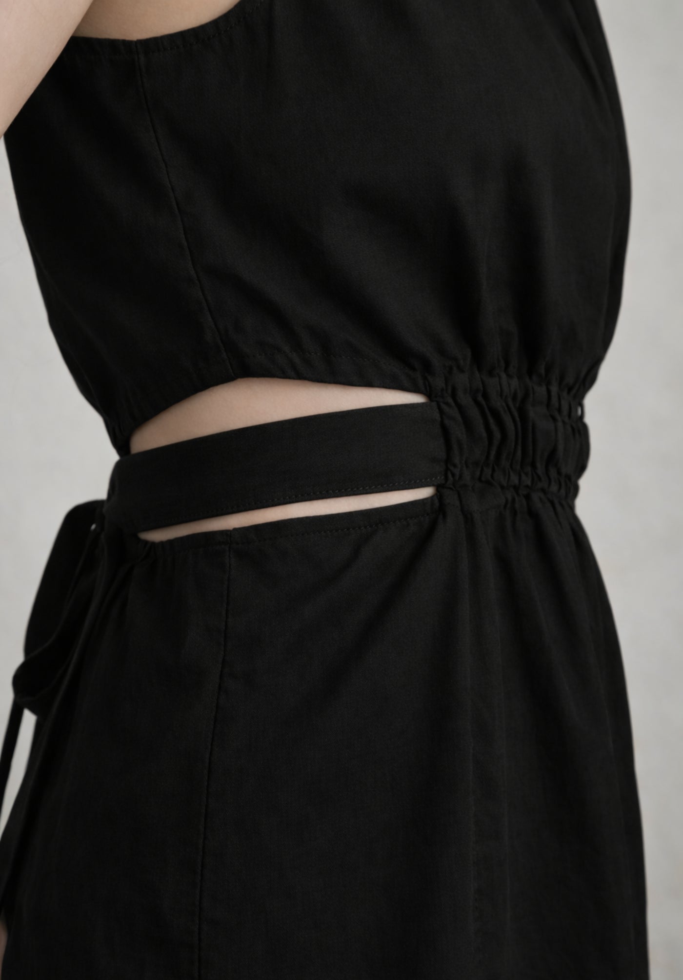 Close-up detail of black cotton dress fabric and stitching