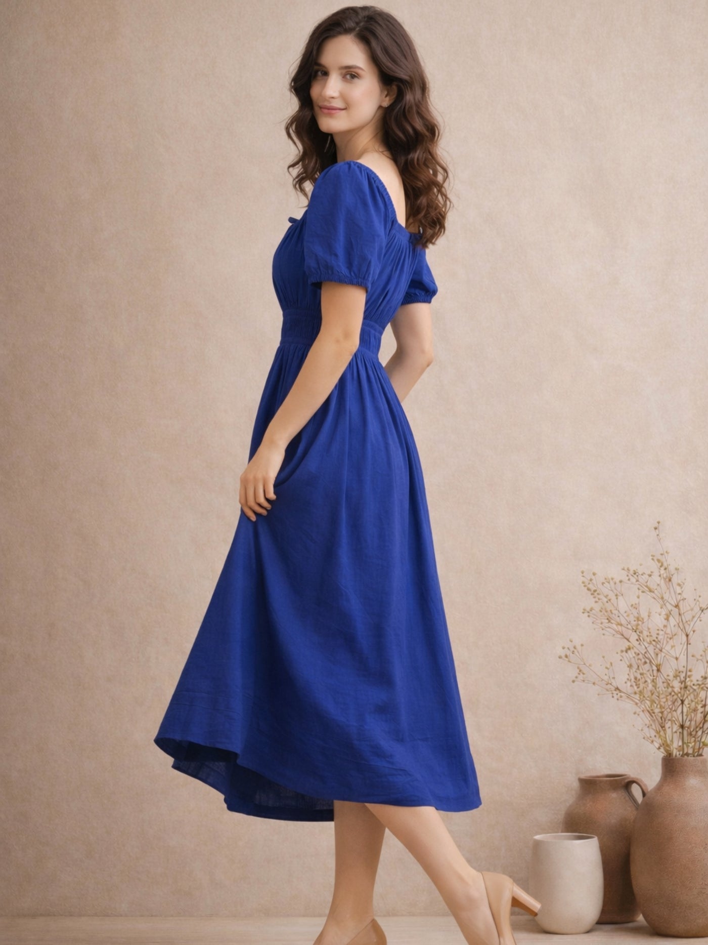 Lifestyle shot of woman wearing blue pure cotton A-line midi dress