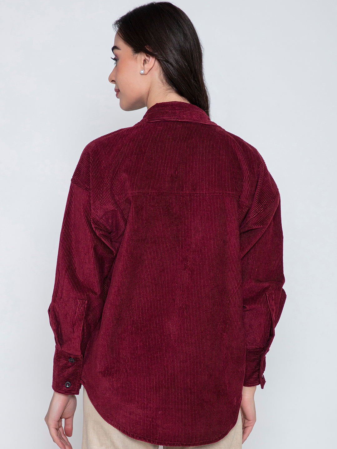 Lifestyle shot of model wearing maroon corduroy oversized shirt